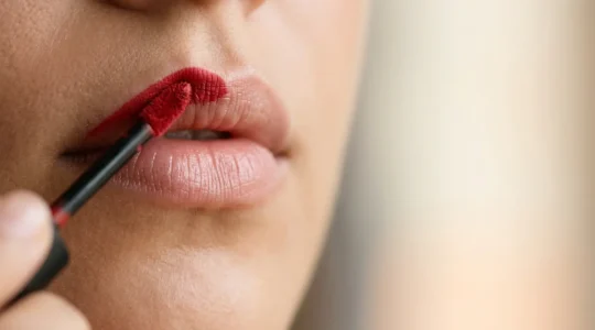 Applicazione elegante di rossetto matte con labbra perfettamente idratate e curate